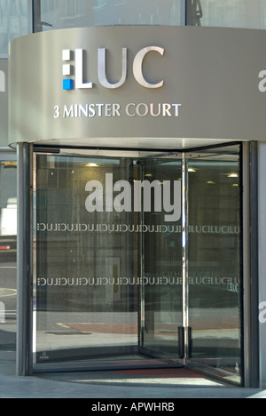 Logo & sign above revolving door entrance to London Underwriting Centre LUC underwriters do business with insurance brokers City of London England UK Stock Photo