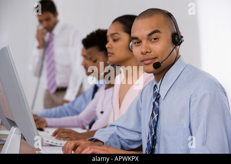 Multi-ethnic businesspeople working at computers Stock Photo