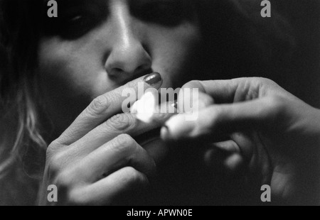 Woman lighting a cigarette Stock Photo