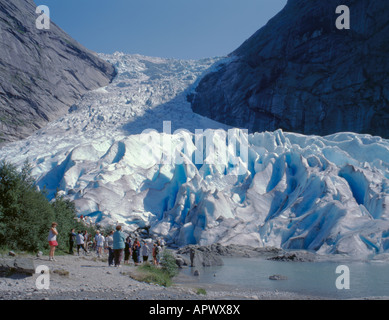 Sightseers at the snout of the Briksdal Glacier, an arm of the Jostedalsbreen, above Olden, Sogn og Fjordane, Norway. Stock Photo