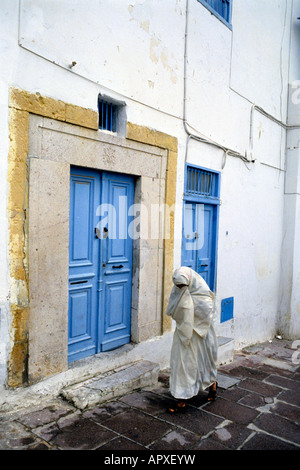 Woman wearing traditional robe or chador walking Stock Photo