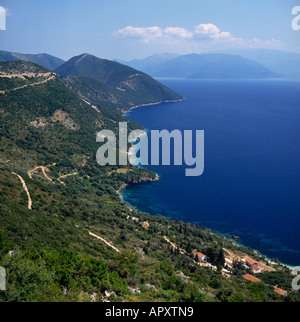 View from west coast along hilly coastline of Ithaca Island with winding roads & Cephalonia hazy in background The Greek Islands Stock Photo