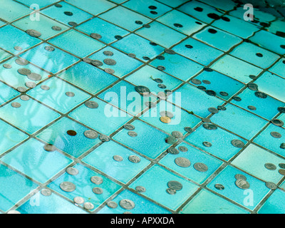 coins of money scattered in a wishing well pool Stock Photo