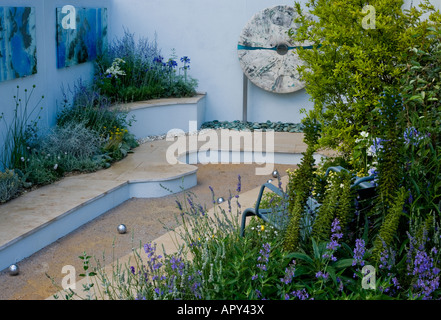 boules in a Japanese garden with seat and art panels on walls Stock Photo
