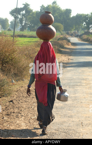 woman with waterjug at her head in india Stock Photo