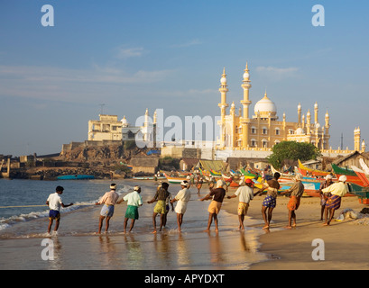 INDIA KERALA VIZHINJAM FISHING VILLAGE FISHERMEN PULLING IN NETS Stock Photo