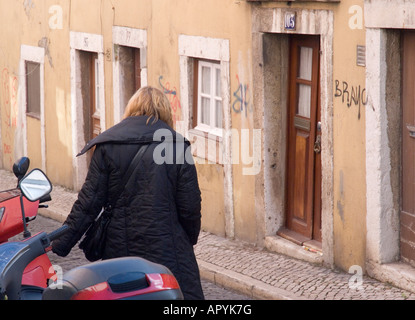 a woman walks through central lisbon portugal Stock Photo