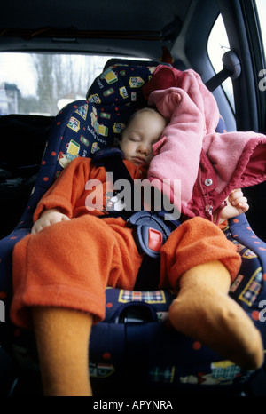 Boy one years old sleeping deeply in a car Stock Photo