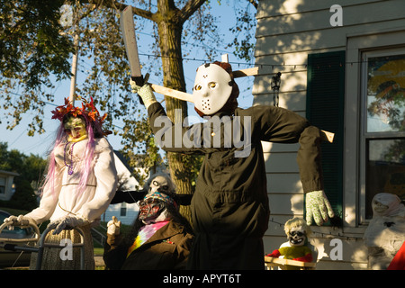 ILLINOIS Dixon Ghoulish Halloween decorations in front yard of house pumpkin head executioner scary people standing Stock Photo
