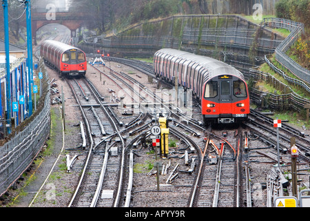 Northern Line trains approach and depart at Finchley Central tube stop in London UK December 5 2007 Stock Photo