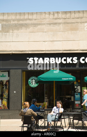 ILLINOIS Oak Park Customers sitting at tables on sidewalk outside Starbucks Coffee shop Stock Photo