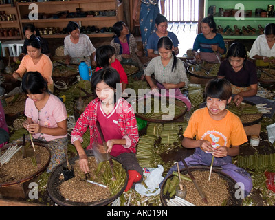 young girls working in a cheroot cigar making factory on Inle Lake in Myanmar Stock Photo