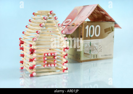 Family houses made from matches and Canadian dollar bills Stock Photo