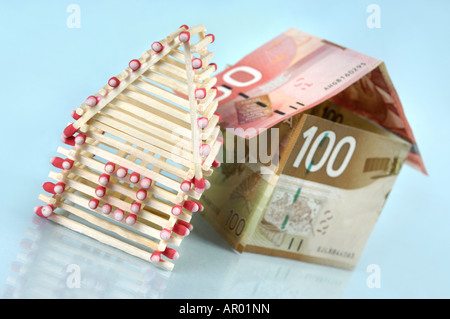 Family houses made from matches and Canadian dollar bills Stock Photo