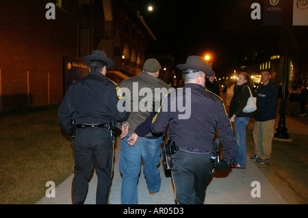 Police arresting a man for rioting Storrs Connecticut following UCONN Basketball national championship win in 2004 Stock Photo