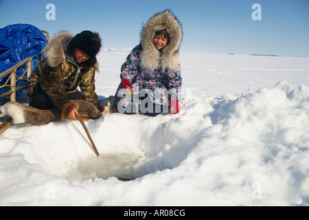 Natives Ice fishing in Kotzebue Western Alaska winter Stock Photo