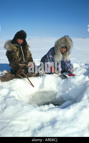 Natives Ice fishing in Kotzebue Western Alaska winter Stock Photo