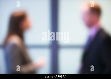 two office workers in conversation out of focus Stock Photo