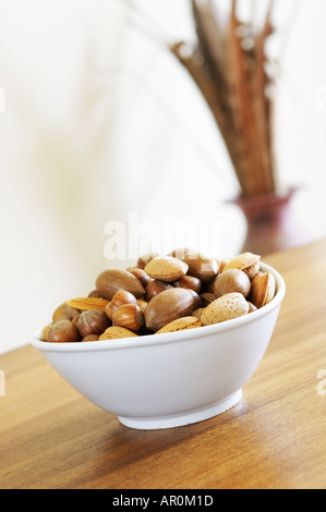 Bowl of nuts on oak wood surface Stock Photo