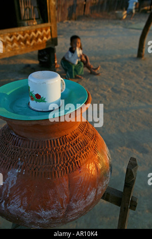 Drinking water in terracotta pot, Wasser aus dem Tontopf, Wasserbehaelter stehen ueberall in Burma traditional water urn, drinki Stock Photo