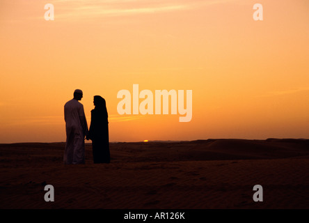 Young arab couple watching sunset Stock Photo