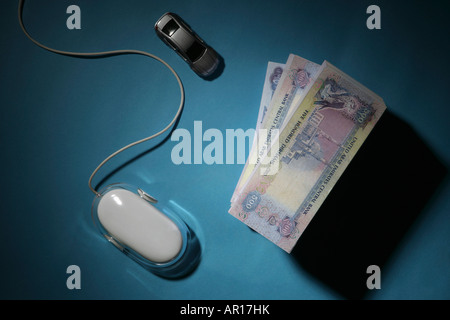 Bundle of Money with Computer Mouse and Car Stock Photo