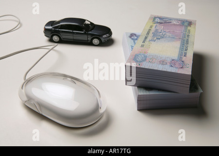 Bundle of Money with Computer Mouse and Car Stock Photo