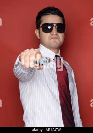 Business man holding a gun Stock Photo - Alamy
