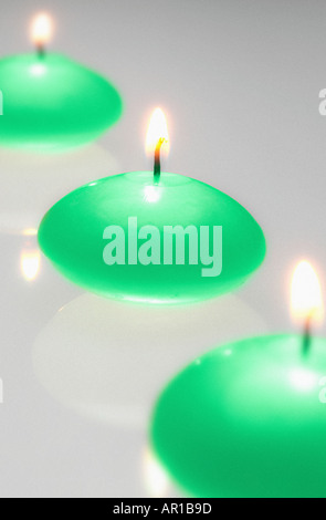 Three green candles burning Stock Photo