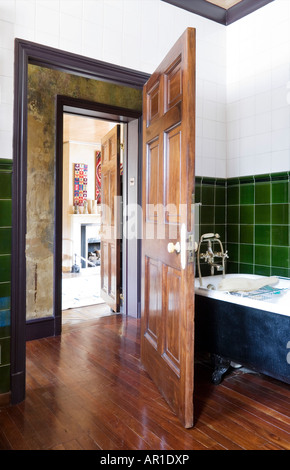 view from bathroom into bedroom of an antique collector's house in London Stock Photo