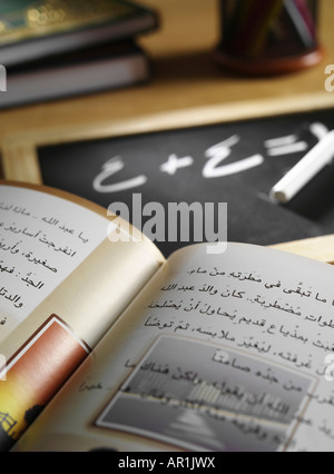 School Book with slate on which numbers are written in Arabic Language Stock Photo