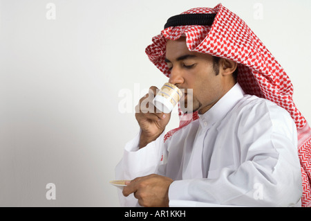 Young Arab man Drinking Coffee Stock Photo