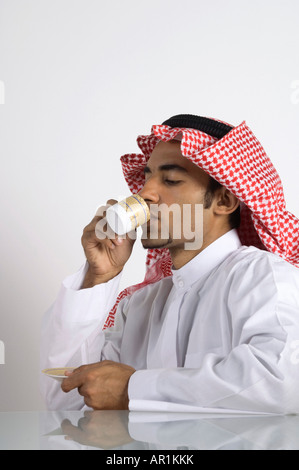 Young Arab man Drinking Coffee Stock Photo