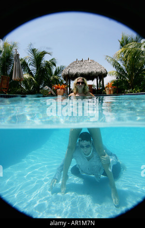 Couple in a pool, man in water Stock Photo