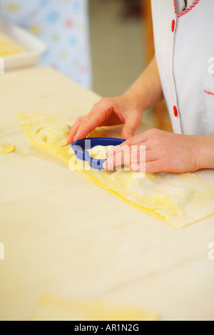 Preparation of hart-shaped ravioli, Italy Stock Photo