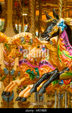 Vertical close up of three horses on an old fashioned traditional carousel at a fair ground Stock Photo