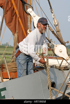 Crew from the SB. Cabby tidying ropes after the Blackwater barge match. Maldon Quay Essex Stock Photo