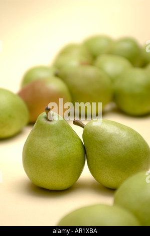 still life image of a group of Anjou pears with two among many fruit leaning on each other Stock Photo