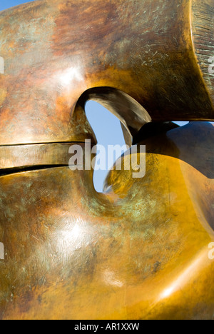 Vertical close up of Henry Moore's Locking Piece bronze sculpture on a bright sunny day. Stock Photo