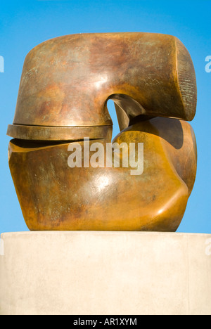 Vertical close up of Henry Moore's Locking Piece bronze sculpture on a bright sunny day. Stock Photo