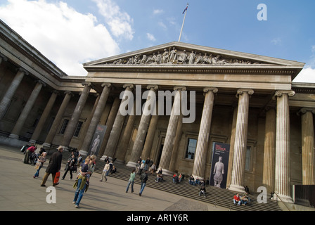 Horizontal wide angle of lots of tourists outside the grand entrance of the British Museum on a sunny day Stock Photo