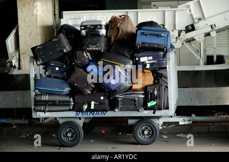 Baggage and suitcases on a Ryan Air trolley at an airport Stock Photo