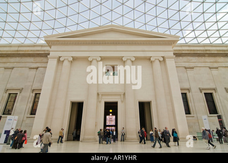 Horizontal wide angle of tourists ambling around the South Portico of the Queen Elizabeth II Great Court in the British Museum. Stock Photo