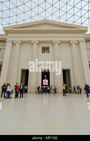 Vertical wide angle of tourists ambling around the South Portico inside the Queen Elizabeth II Great Court in the British Museum Stock Photo