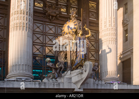 Horizontal close up of Gilbert Bayes ornamental 'Queen of Time' statue and clock above the entrance to Selfridges on Oxford St. Stock Photo