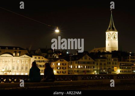 photograph of girls chatting at night in zurich overlooking the river walk promenade Stock Photo