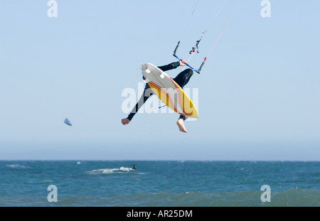 Kite surfer losing control after launching off the crest of a wave Stock Photo