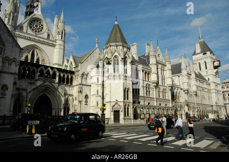 Solicitor crossing the road outside the Royal Courts of Justice in The Strand London England Stock Photo