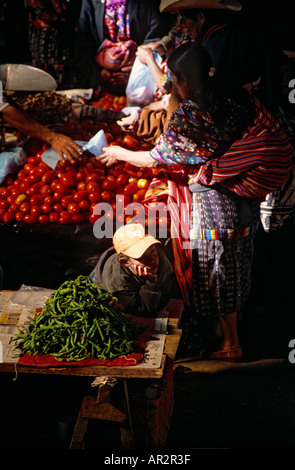 Boy daydreaming at vegetable stall, Chichicastenango market, Highlands, Guatemala, Central America. Stock Photo