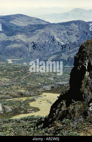 Looking down a rocky cliff from the crater rim of Mount Elgon to the floor of caldera of this ancient volcano in Western Kenya Stock Photo